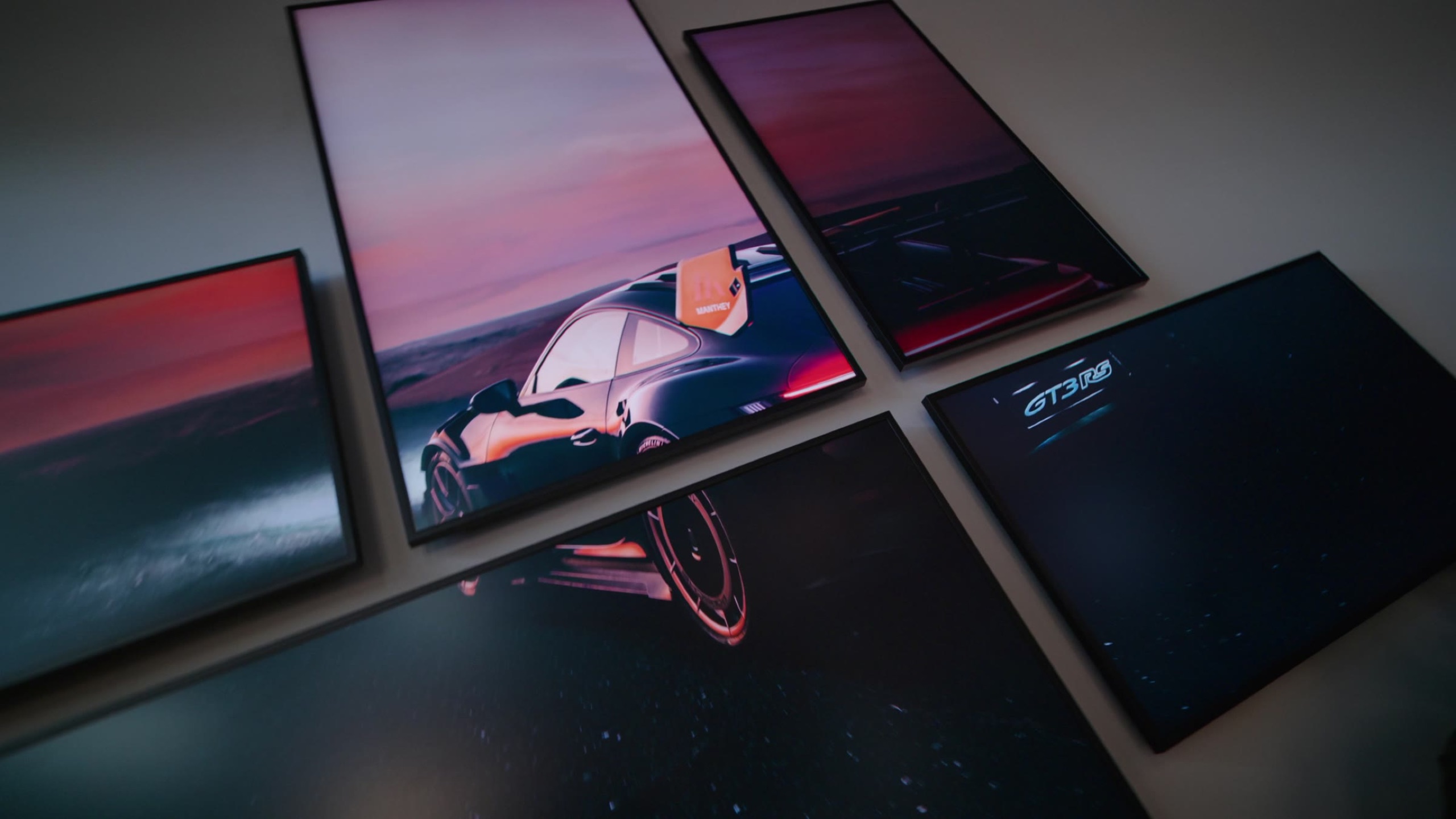 Framed GT3 RS artwork arranged on a table