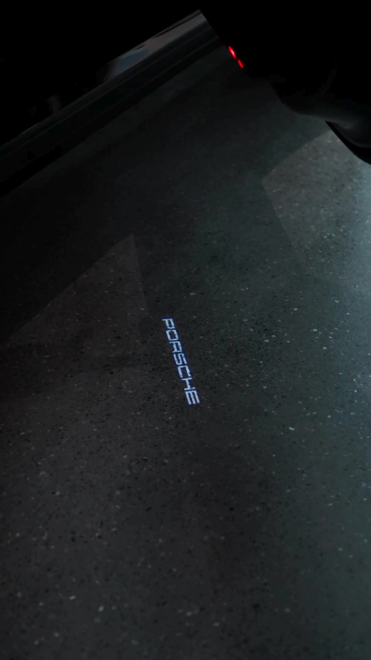 Illuminated Porsche script on the studio floor