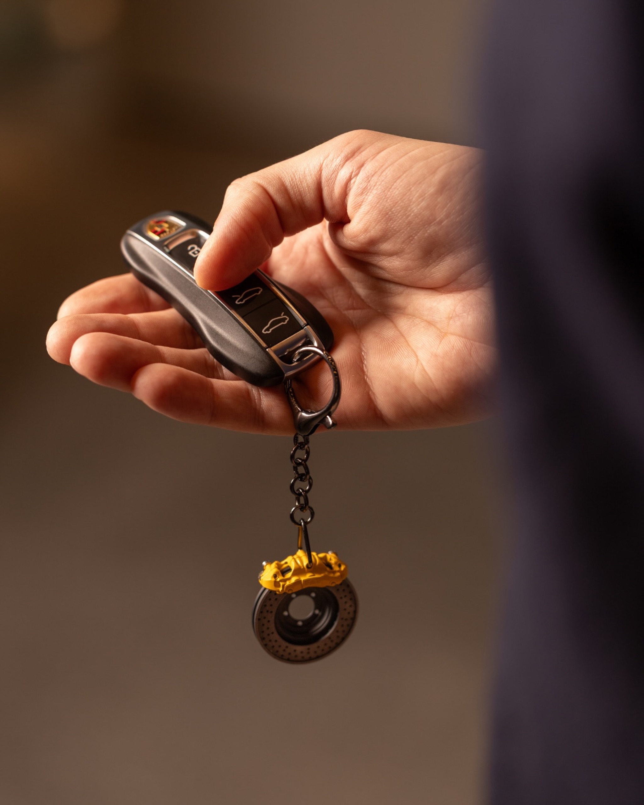 Hand holding a brake disc key ring