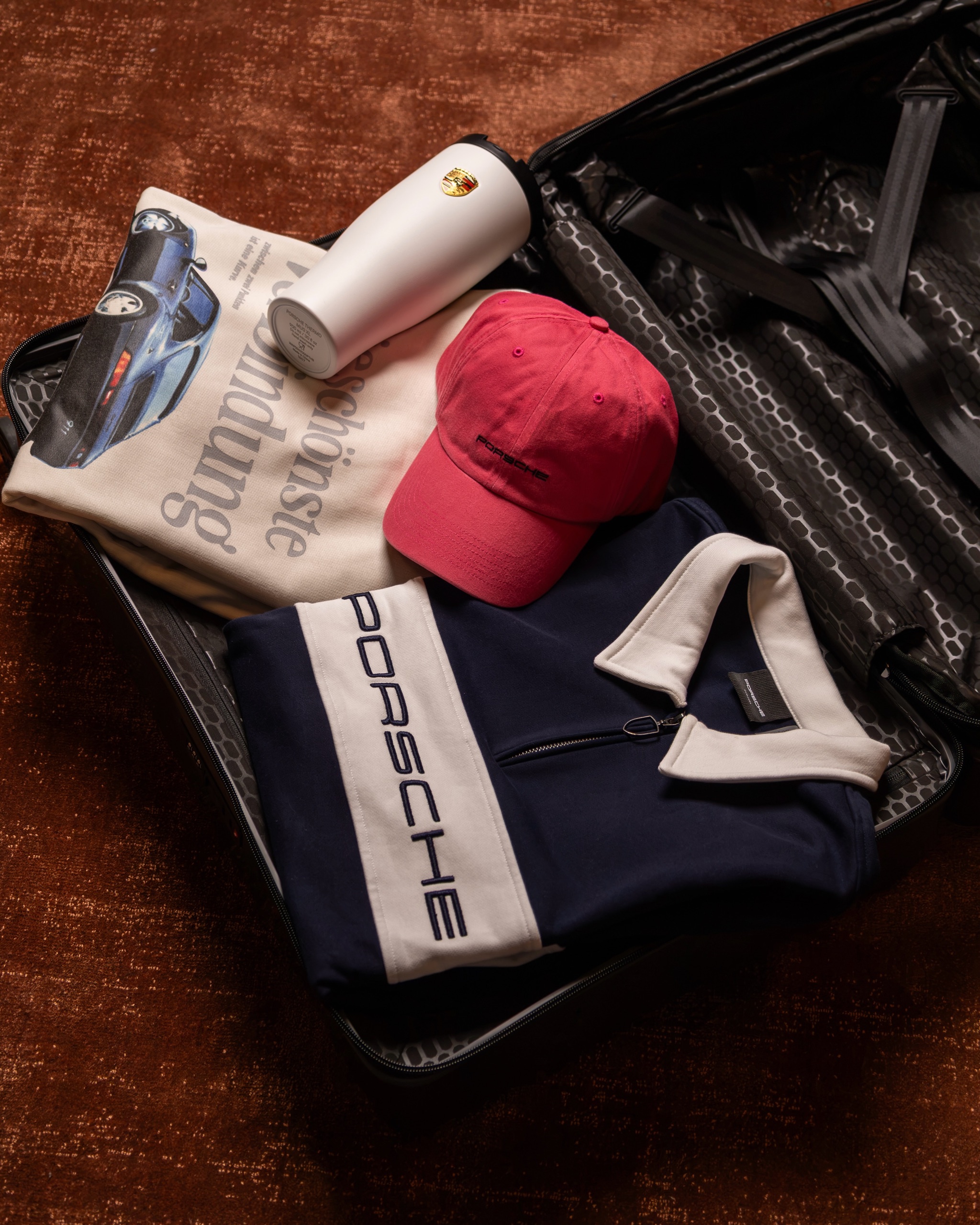Lifestyle collection styled as a flat lay with cap, polo and bottle