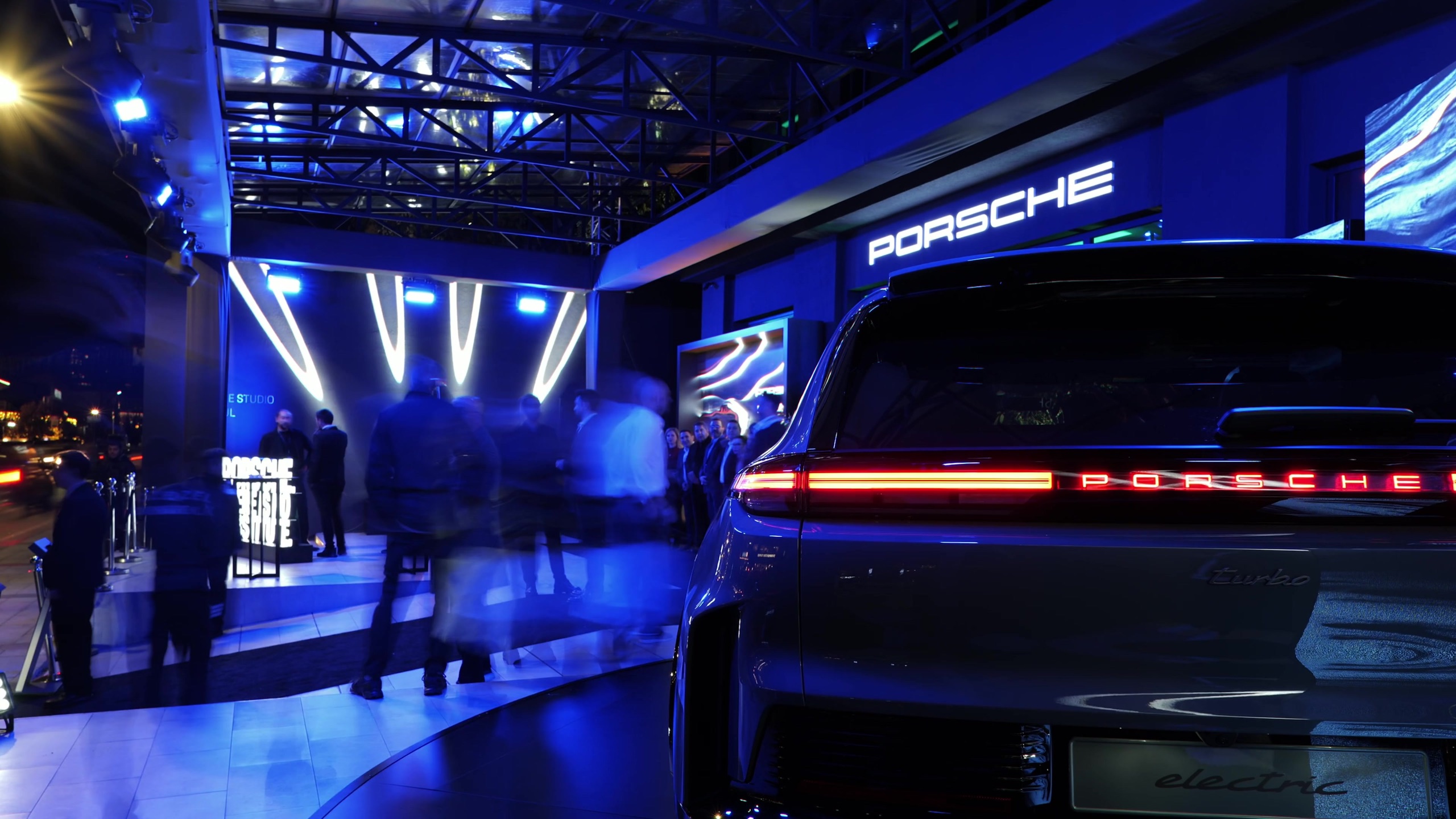 Porsche light bar glowing under blue stage lighting