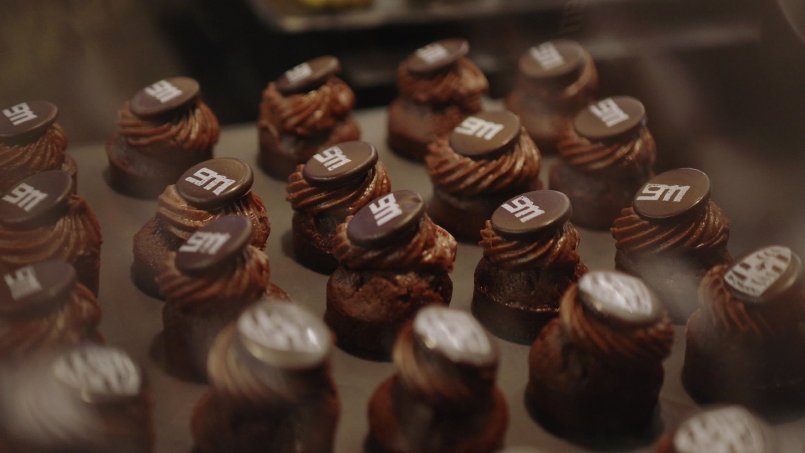 Petits fours topped with 911 chocolate medallions