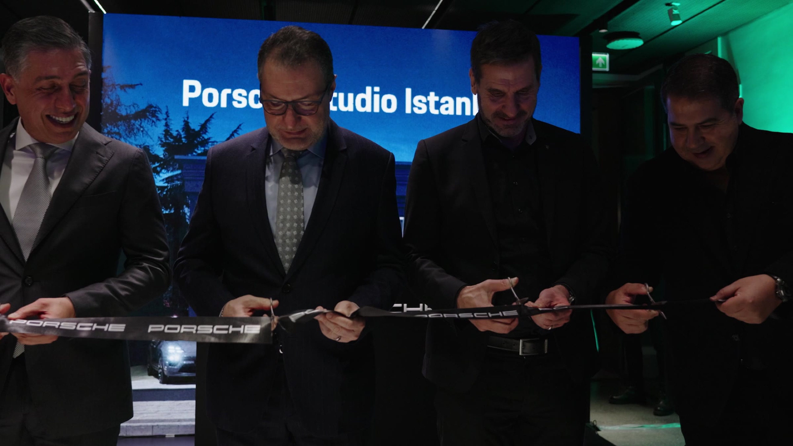 Hosts cutting the Porsche ribbon to open the studio